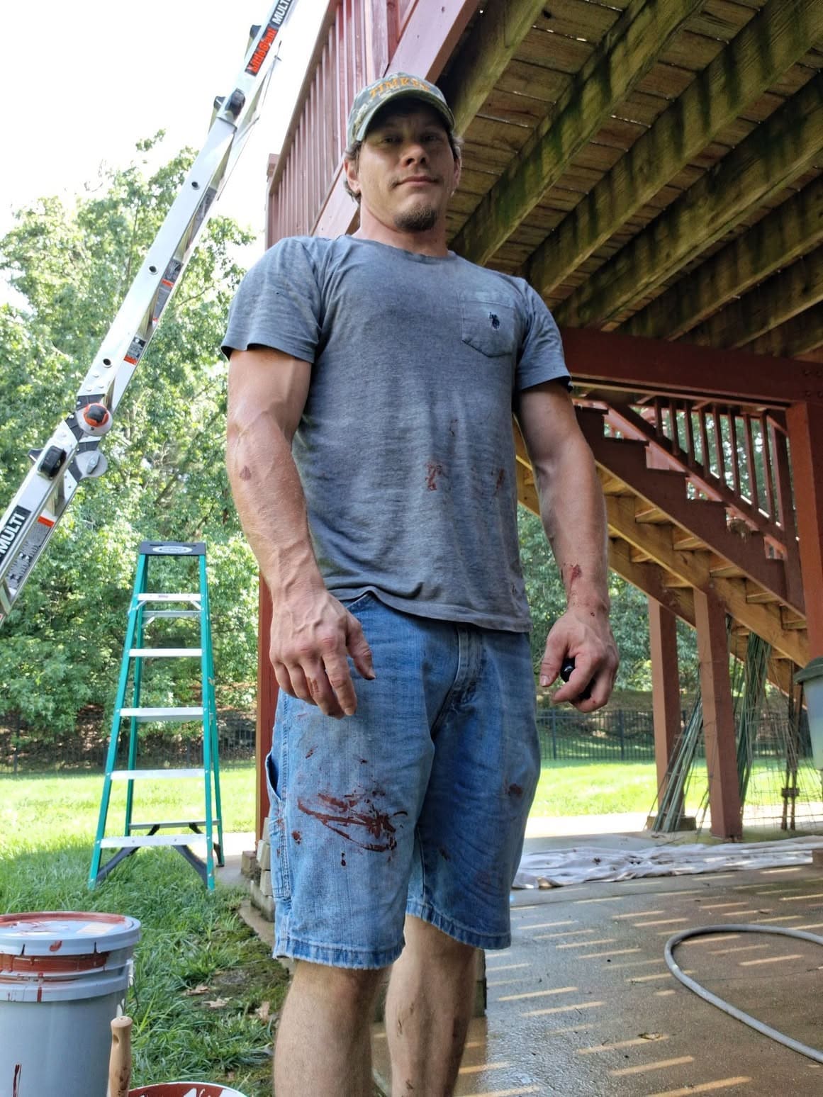 Steven Sansoucie standing beneath a deck at a worksite