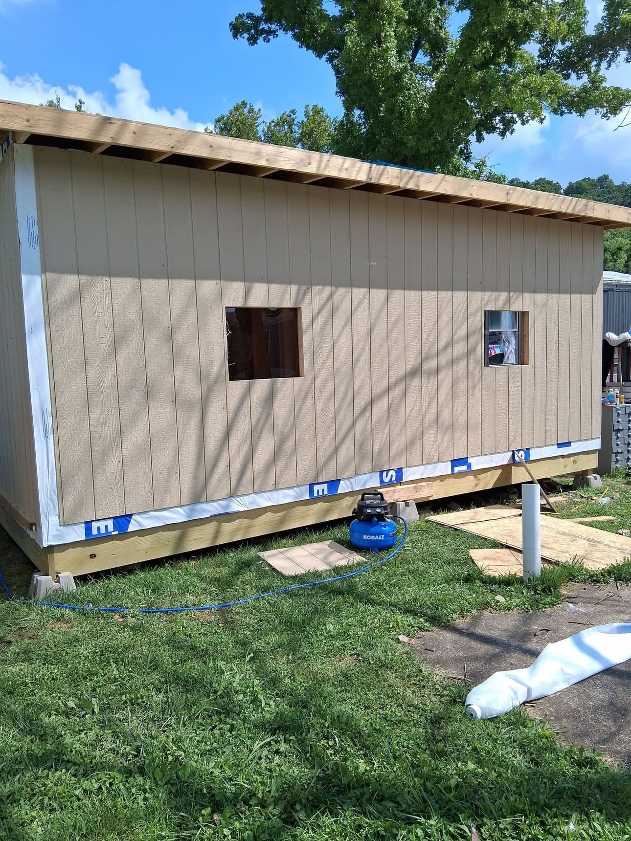 Siding installation on a small outbuilding